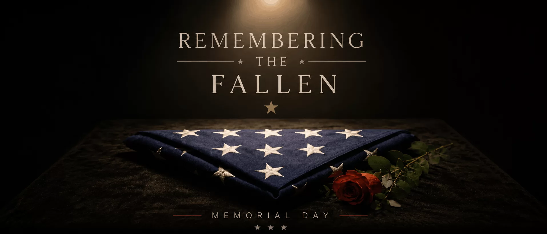 Folded American flag with a red rose on a dark table, honoring fallen service members at Memorial Day, with 'Remembering the Fallen' text above.