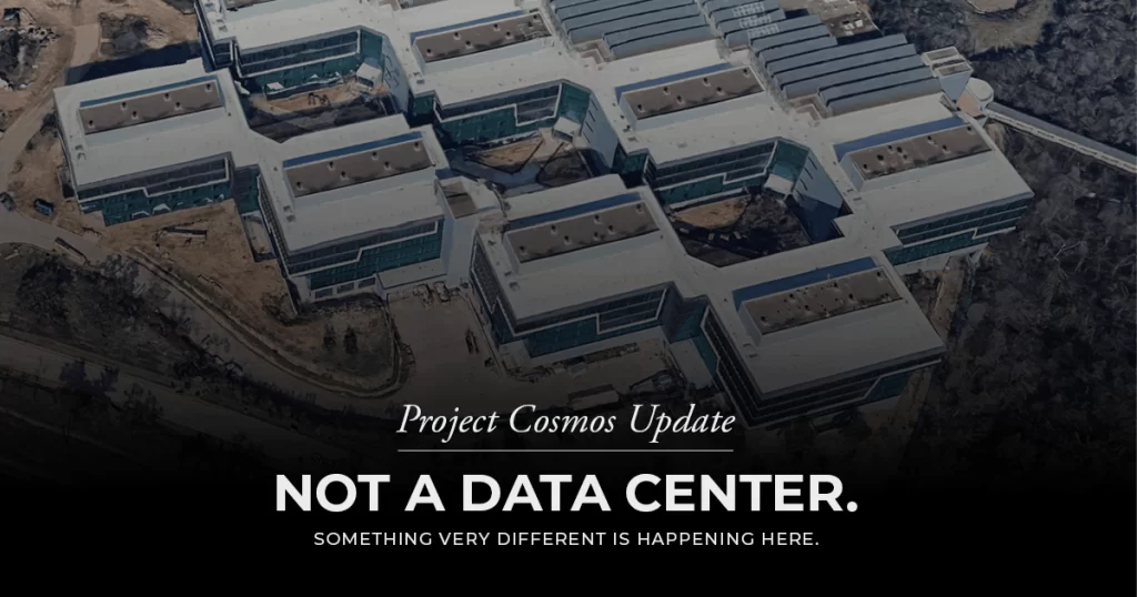 Aerial view of a multi-wing modern building complex with white roofs, acting as a hero banner for 'Project Cosmos Update' with the bold message 'NOT A DATA CENTER.'